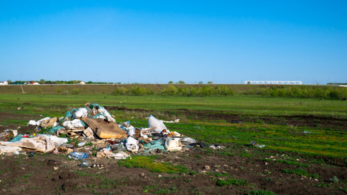 A,Garbage,Dump,In,A,Rural,Field.,Polluted,Summer,Landscape.